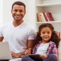 Father with daughter doing remote learning