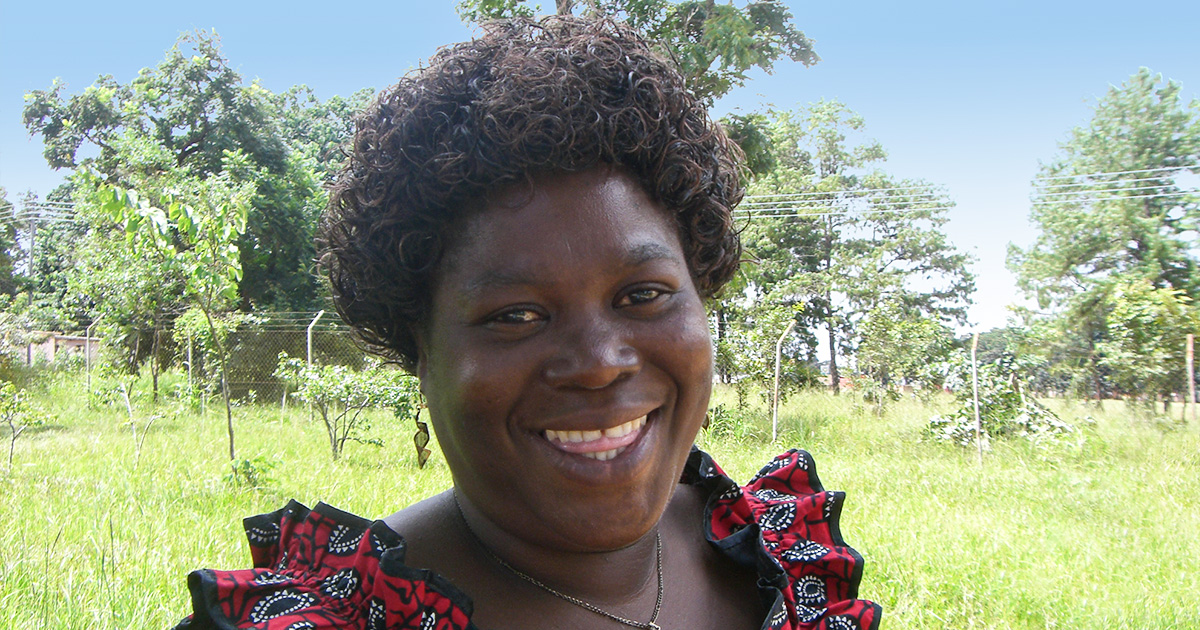 A woman smiles at the camera. 