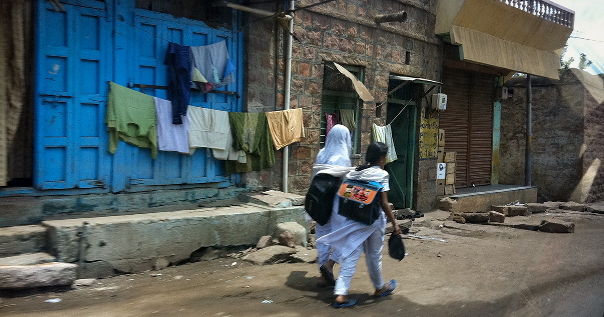 Two women walk down the street