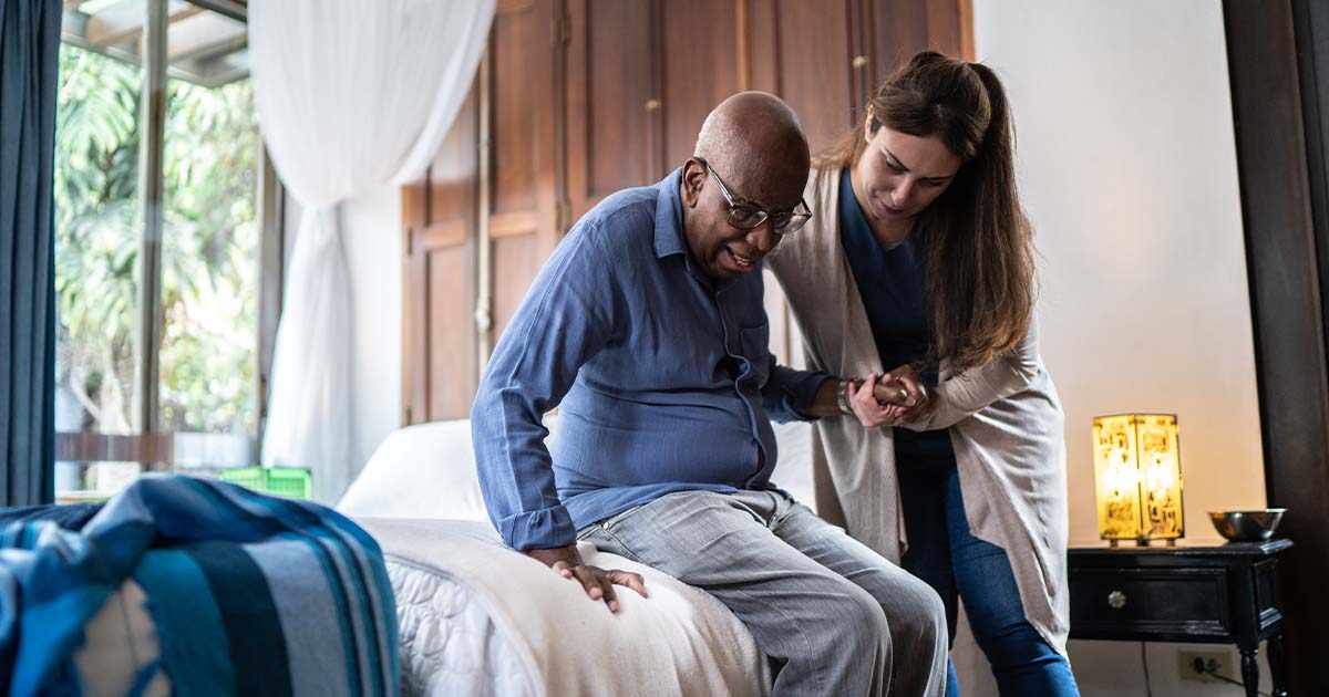 Home health care aid assisting a patient