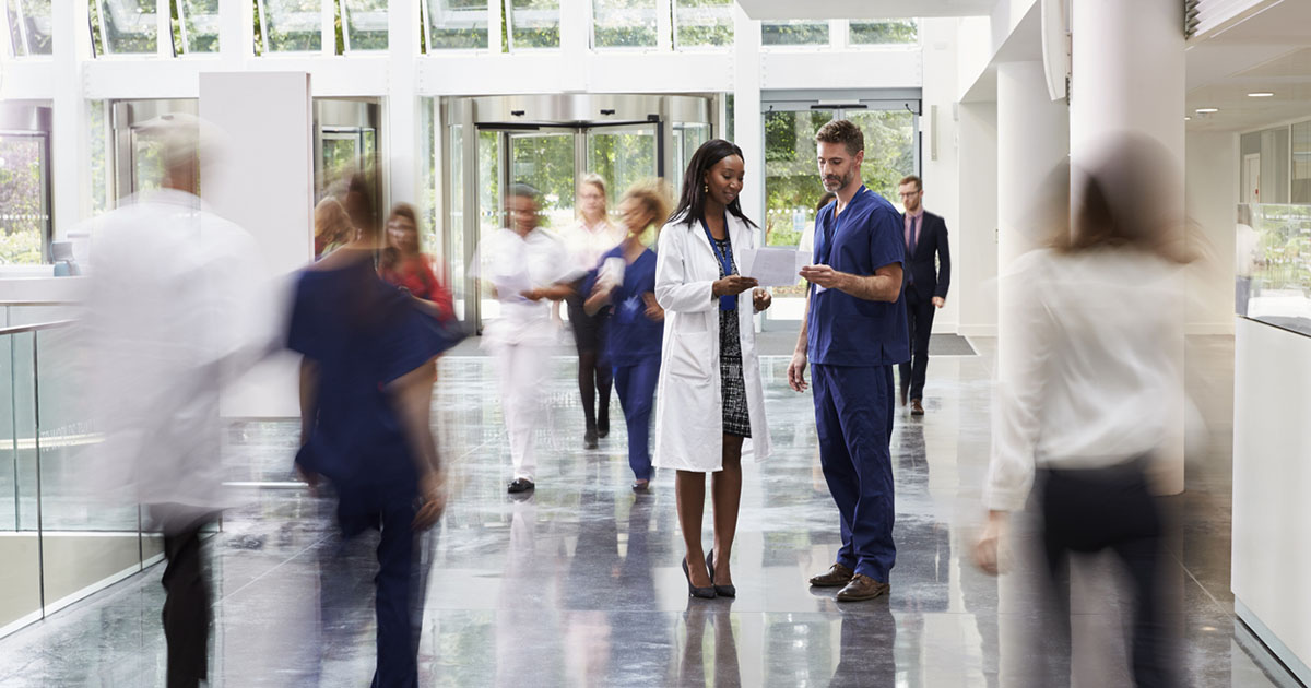 Medical professionals gather in hallway 