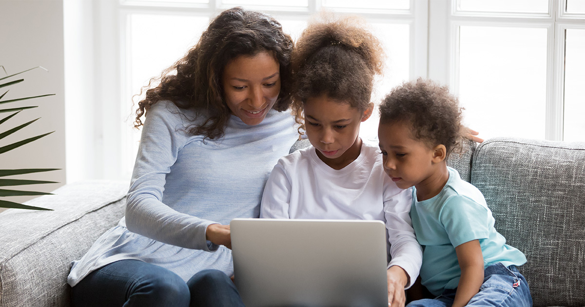 mother happily looking at a tablet with her kids