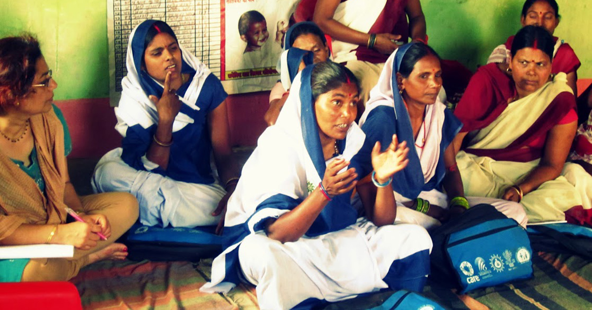 The author in a subcenter meeting with community health workers during a 2013 field visit for the Ananya evaluation to improve maternal and child health and nutrition outcomes in Bihar, India.