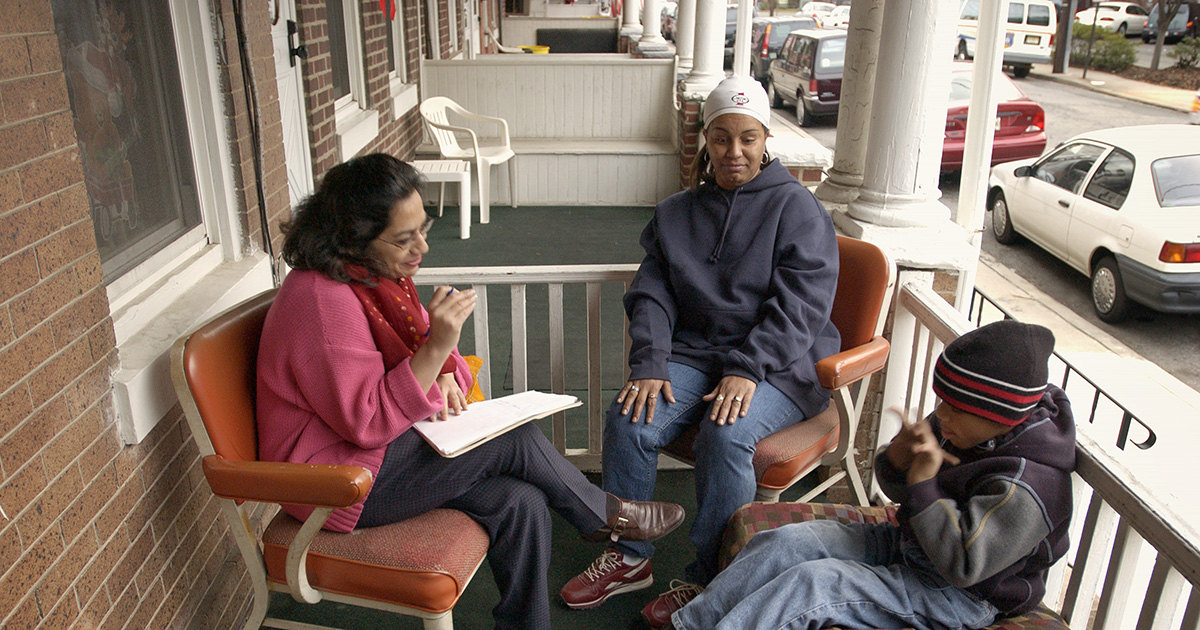 Anu Rangarajan talking with a mother and a child