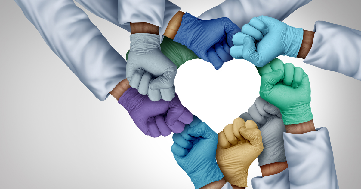 Medical professionals hands surrounding a heart