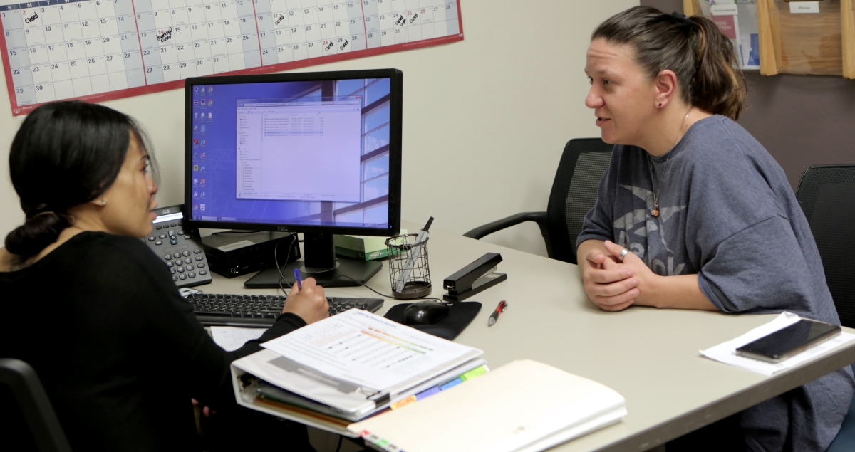 a person sitting at a desk with a computer