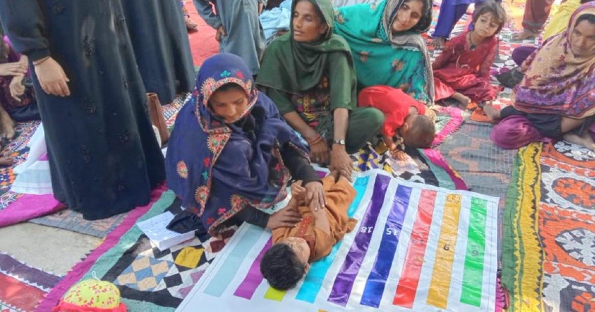 a group of people sitting on a blanket