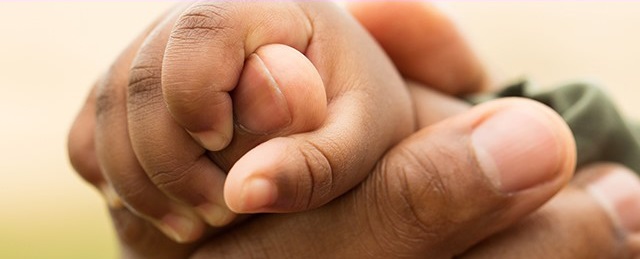 Father's hand holding a child's hand