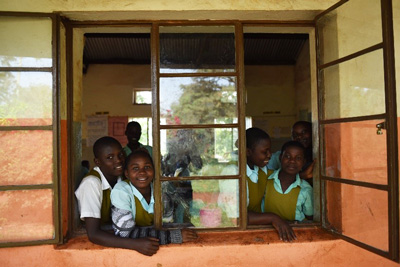 Photo of school children looking out window