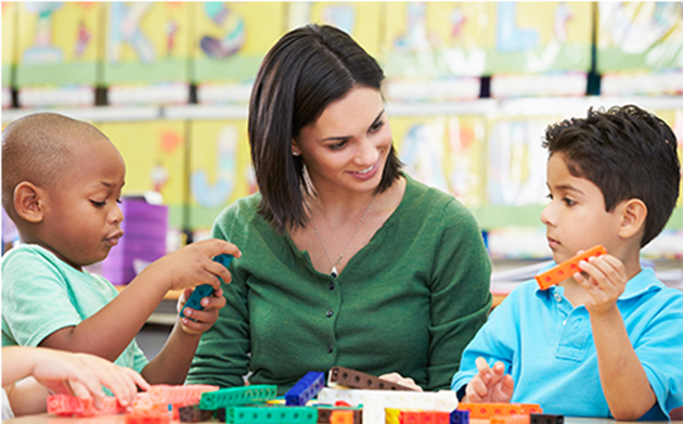 Preschool children counting with teacher in classroom