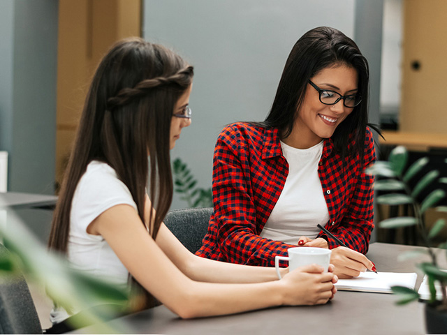 Two female business entrepreneurs working together in an office