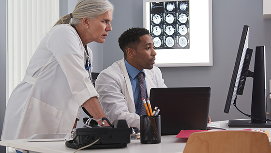 Physicians reviewing data on computer