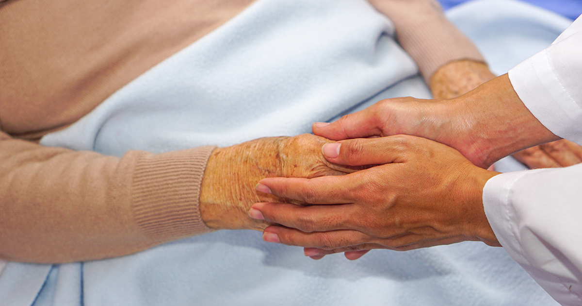 Doctor holding woman's hand