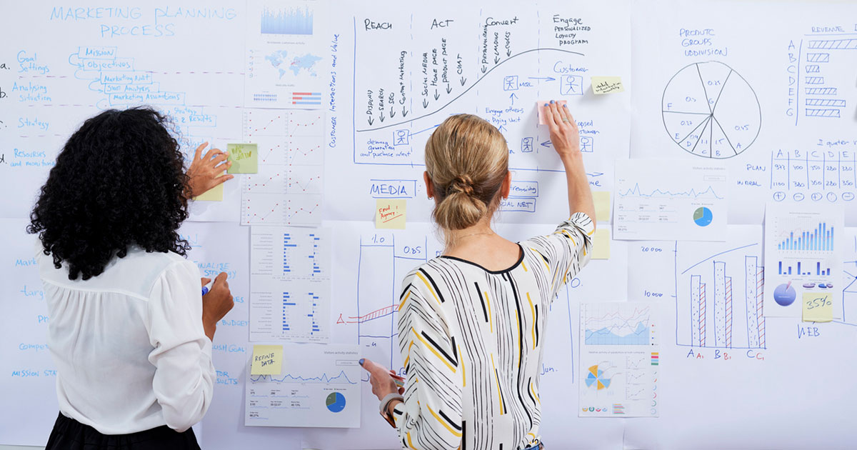 Women with analytics chart
