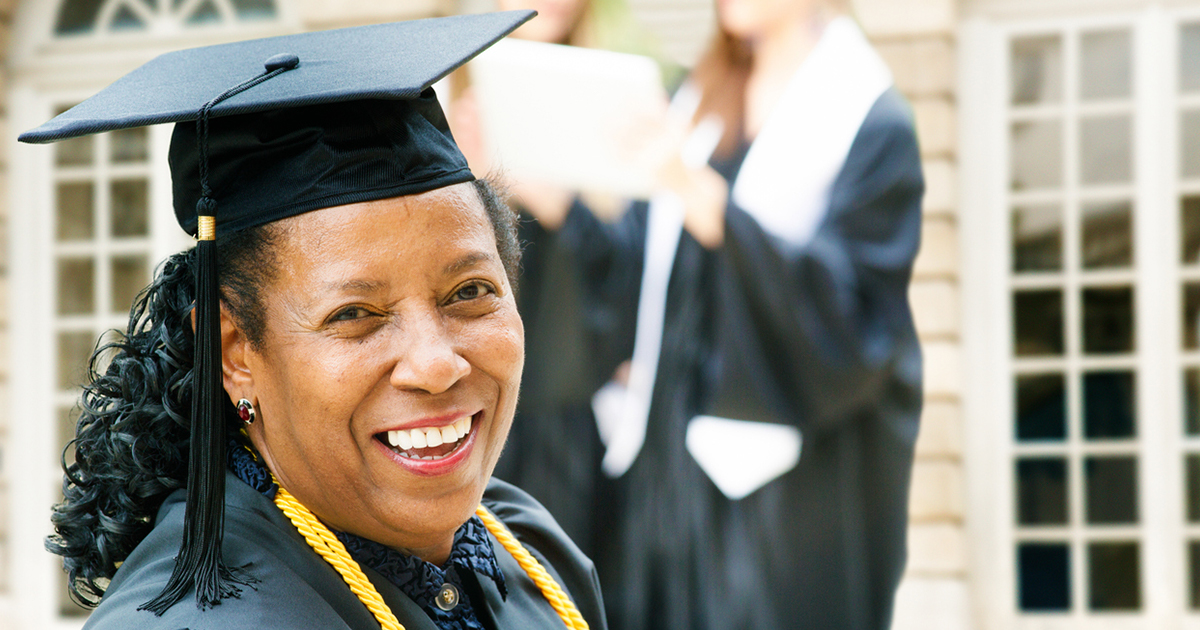 Adult woman in graduation cap and gown