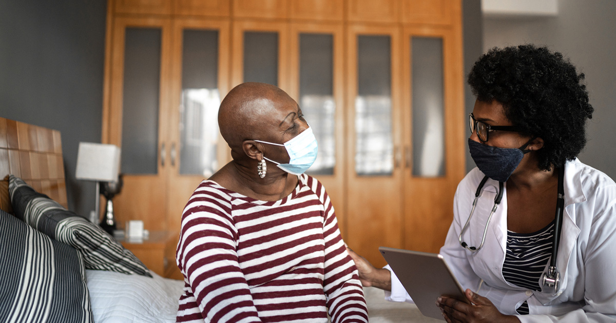 Health visitor and a senior woman during nursing home visit