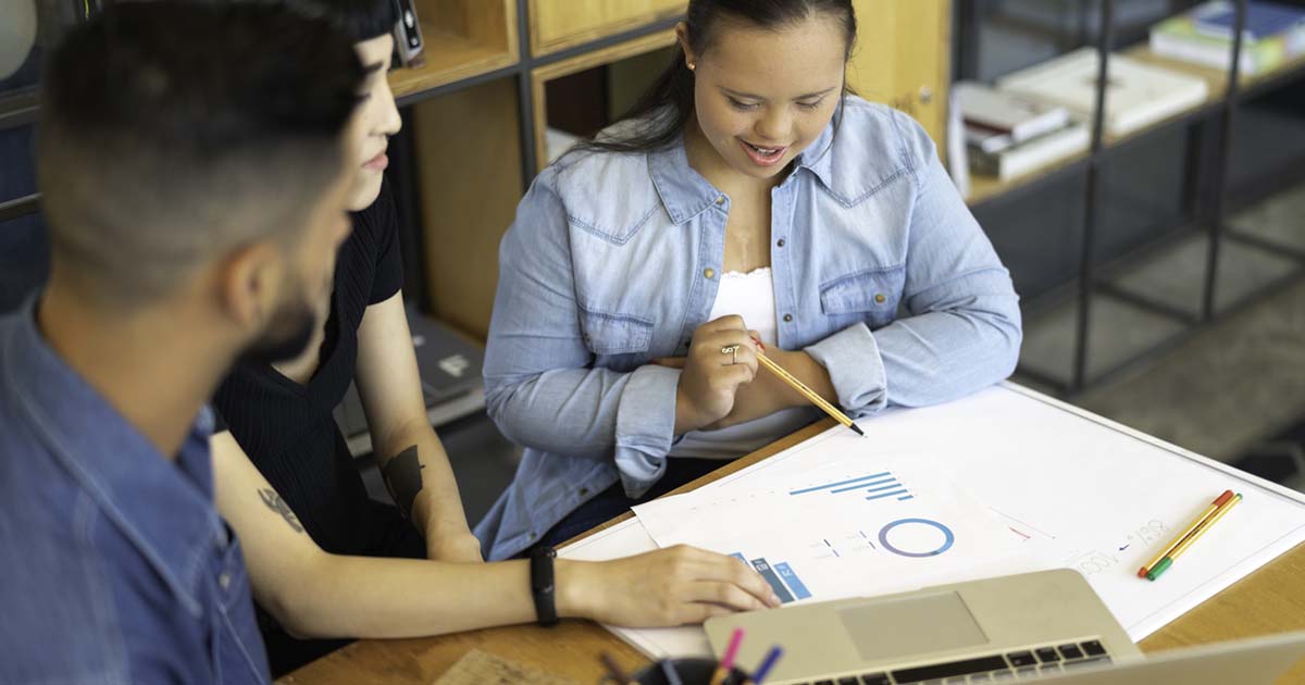 girl looking at charts with two adults