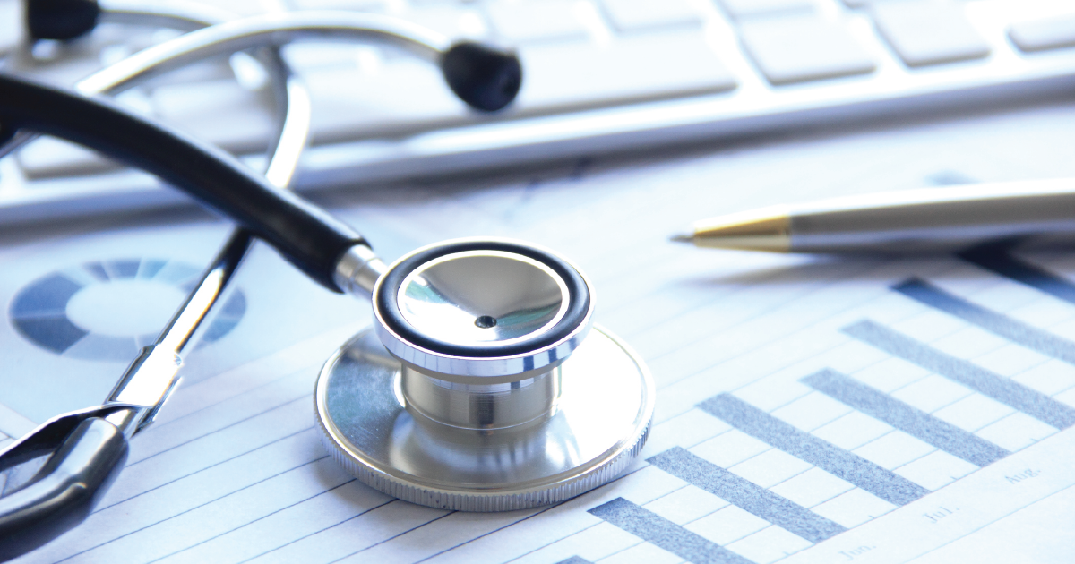 a stethoscope on a paper with a pen and a keyboard