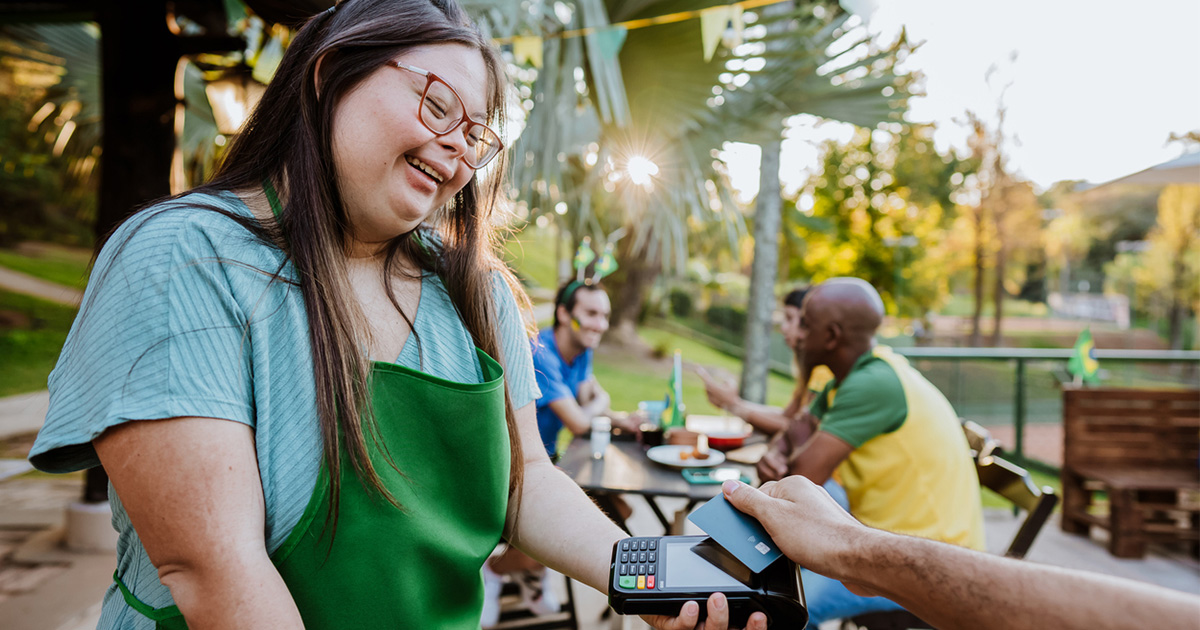 Youth taking a payment from a customer