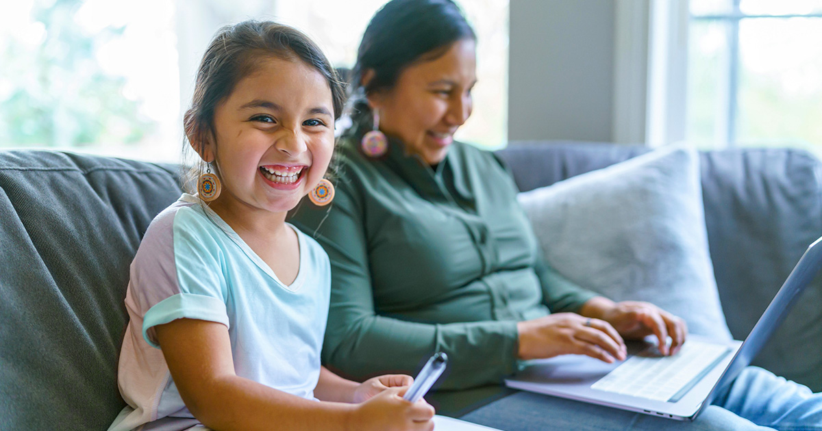 Smiling native mother and daughter