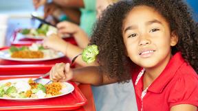 young girl eating school lunch