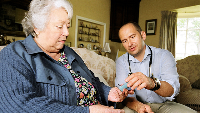 Physician helping woman with medication