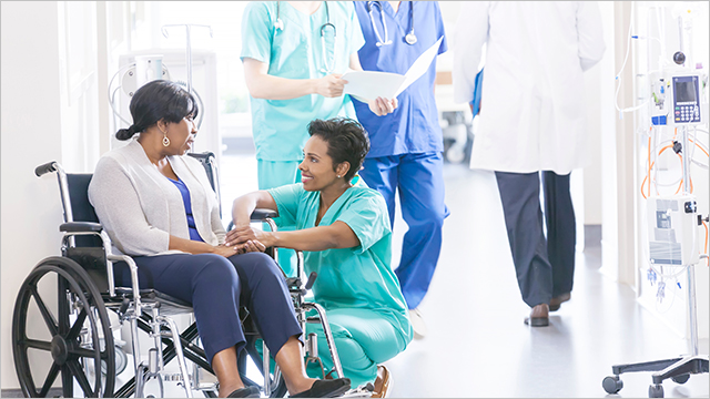 Nurse assisting woman in wheelchair