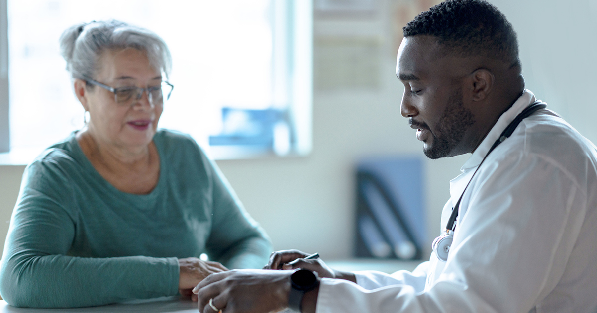 a doctor and a person sitting at a table