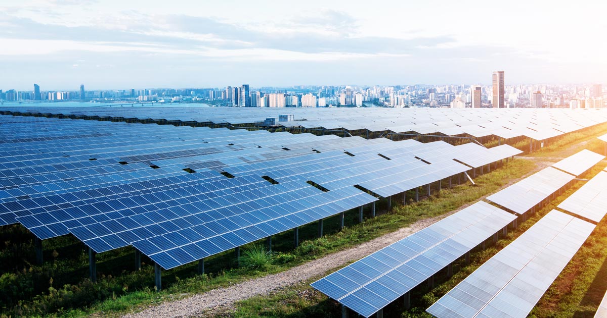 Solar panels in front of a city skyline