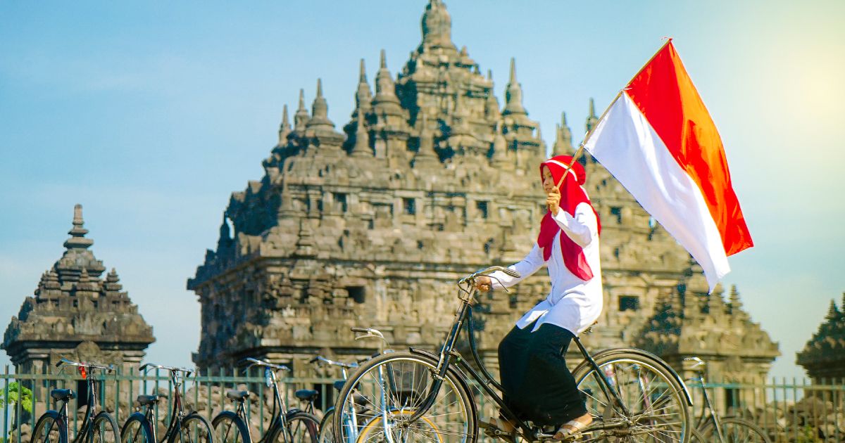 Asian Hijab flapper Indonesian flag in bicycle,