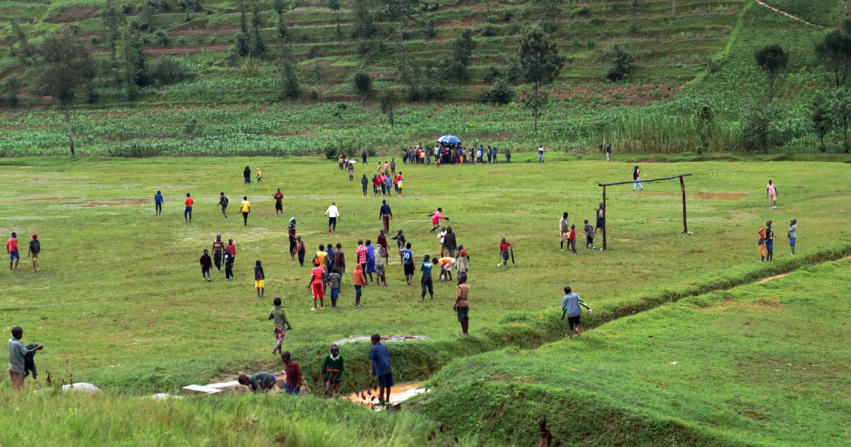 Local youth gathering an a football field in a rural area near Rubavu, Rwanda