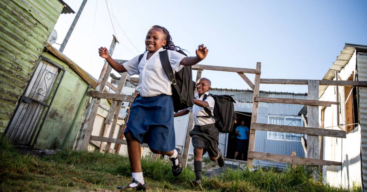 Running and smiling African school children