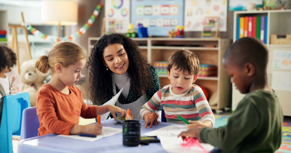 A teacher works with a group of young children