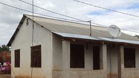A house in Tanzania with electric lines running overhead
