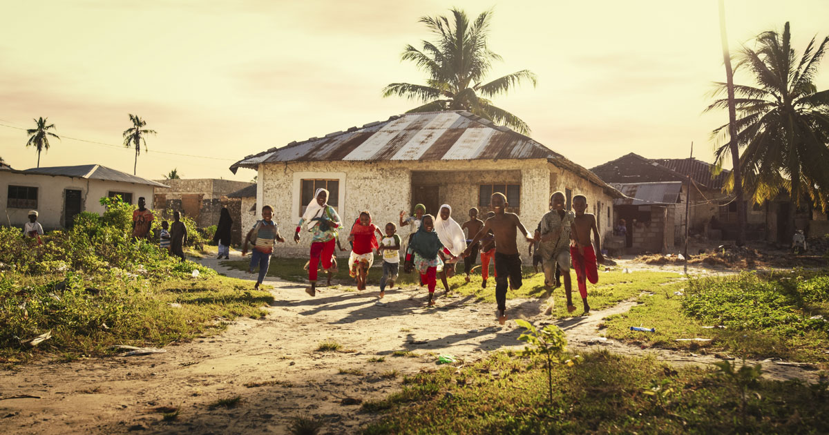 Group of Little Children Running Towards the Camera and Laughing in Rural Village in Tanzania