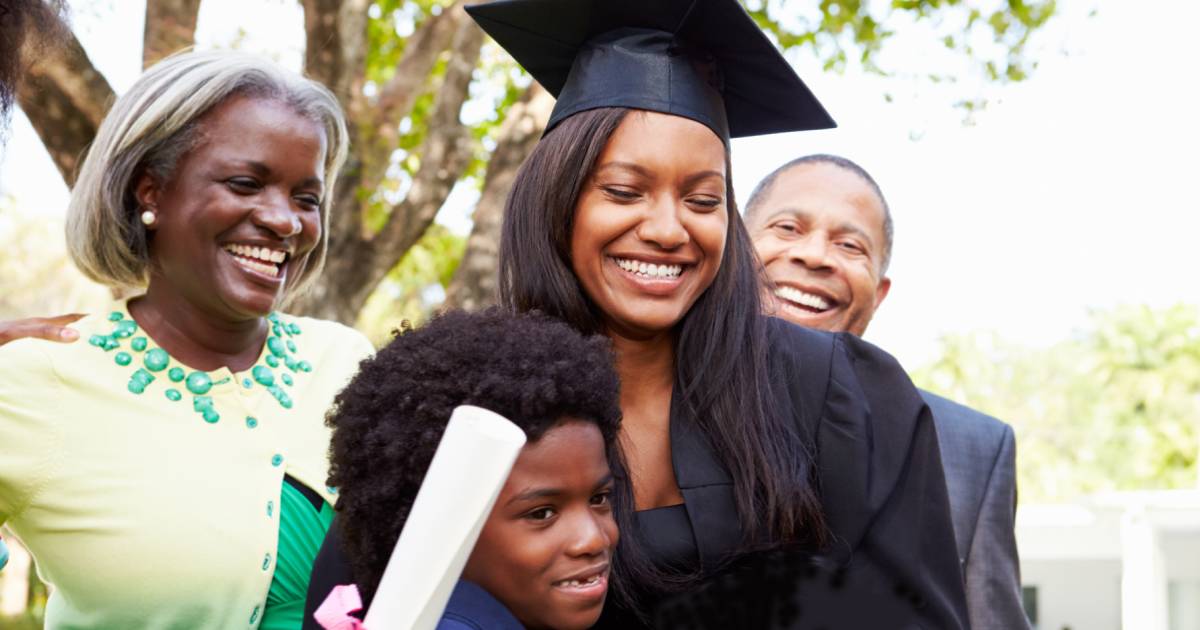 A woman celebrates her graduation with family.