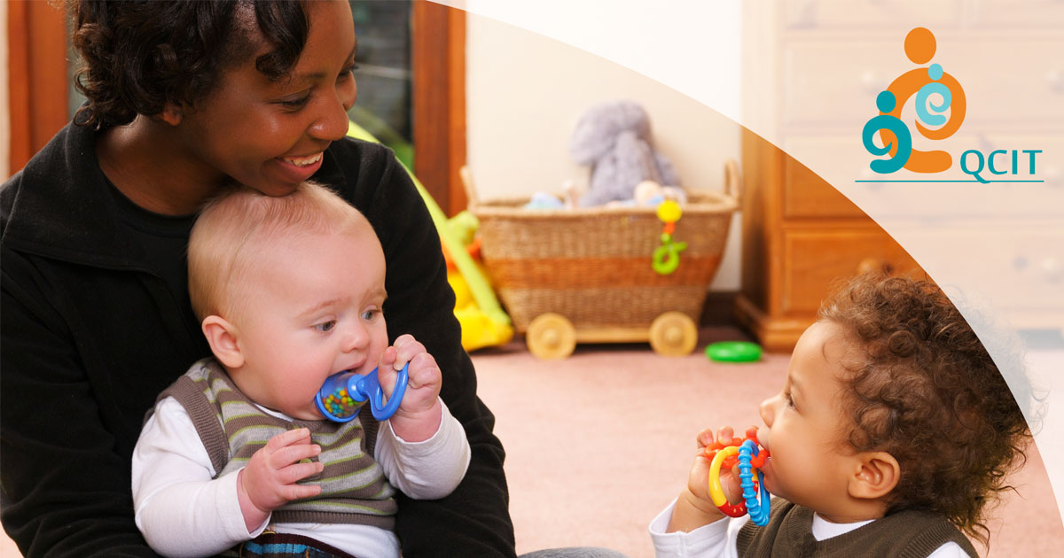 Two toddlers with a caregiver