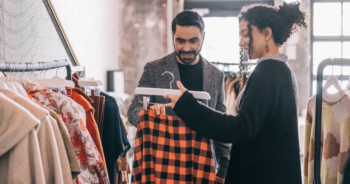 Man and woman looking at a shirt in a clothing shop